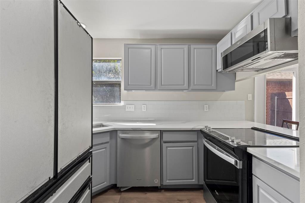 420 Seminary Ridge Mesquite, TX 75149 - Photo 10 of 36 a kitchen with stainless steel appliances granite countertop a sink and a stove top oven