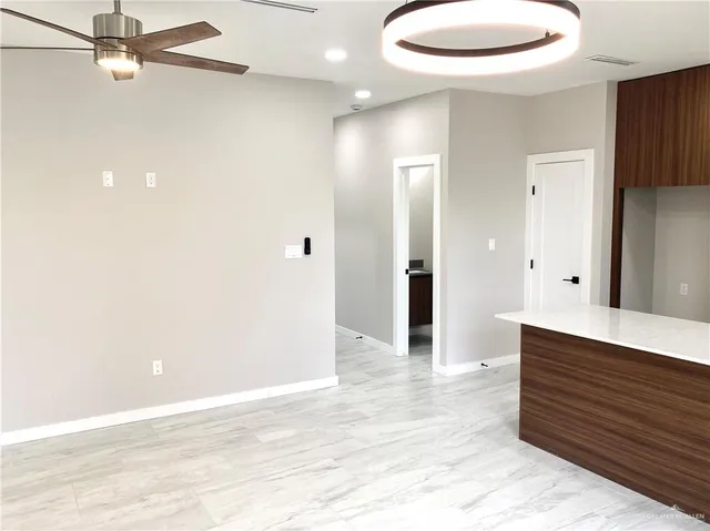 a view of a room with a white cabinet and a granite floor
