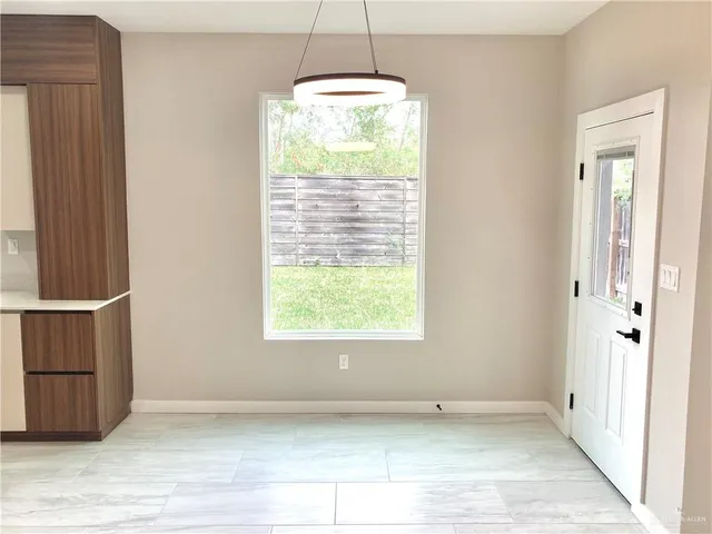 a view of a hallway with a chandelier fan