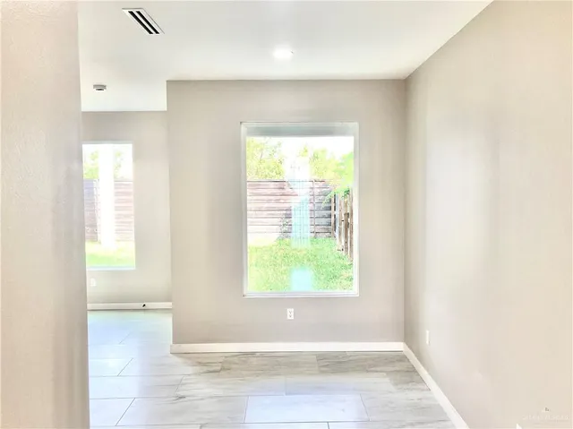 a kitchen with stainless steel appliances kitchen island granite countertop a refrigerator and a sink