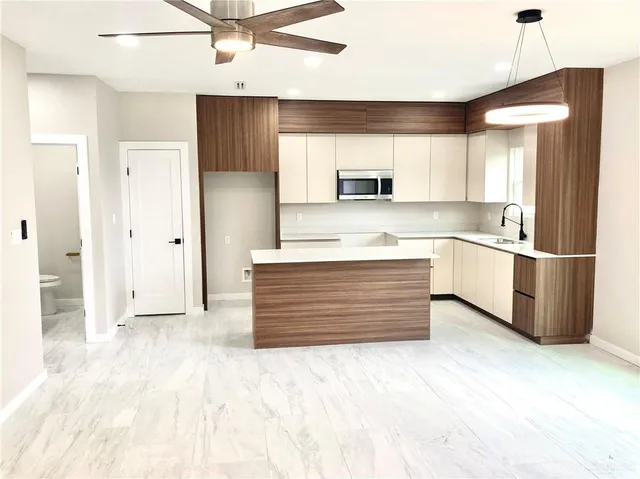 a kitchen with a sink cabinets and a window