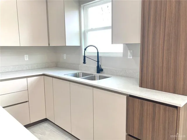 a kitchen with a sink a window and a counter top space