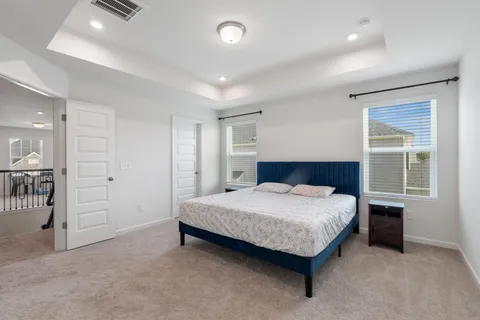 a spacious bathroom with a double vanity sink a large mirror and a shower