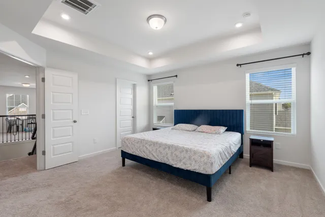 a spacious bathroom with a double vanity sink a large mirror and a shower