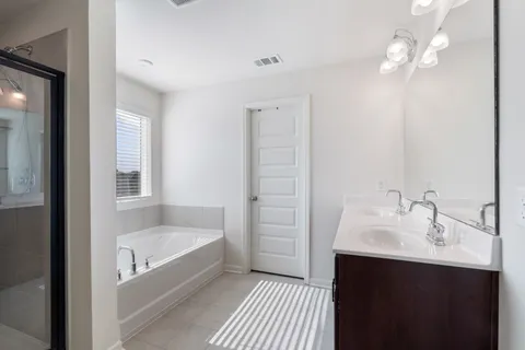 a bathroom with a double vanity sink a and a mirror