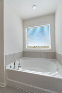 a view of an empty room with closet and a window