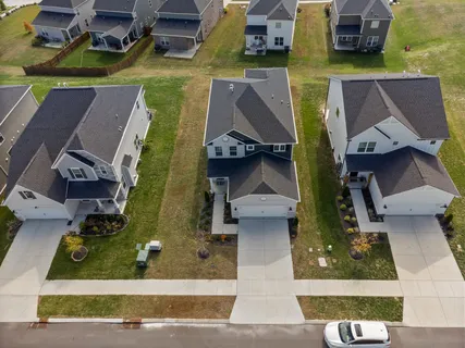 an aerial view of residential houses with outdoor space
