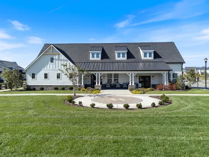 a front view of a house with swimming pool having outdoor seating