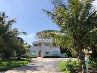 a front view of a house with a yard and a garage
