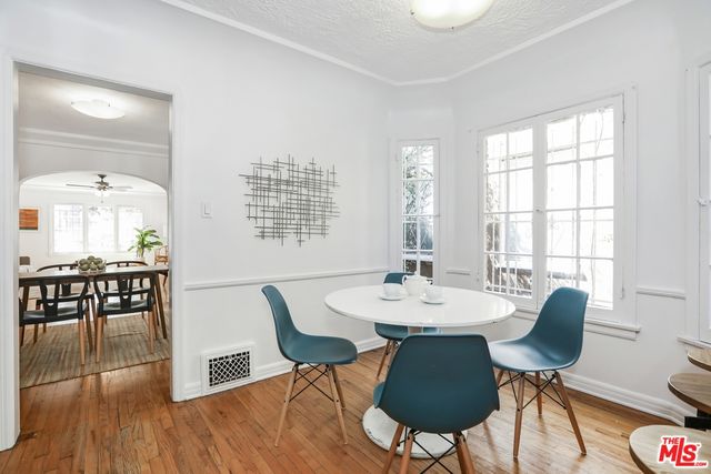 a view of a dining room with furniture window and wooden floor