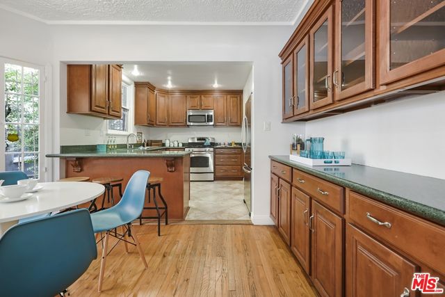 a kitchen with stainless steel appliances granite countertop wooden cabinets a sink and dishwasher