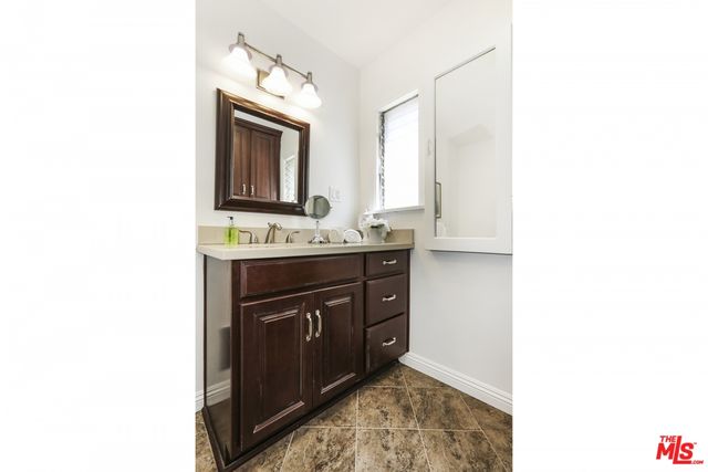 a bathroom with a sink a vanity and a mirror