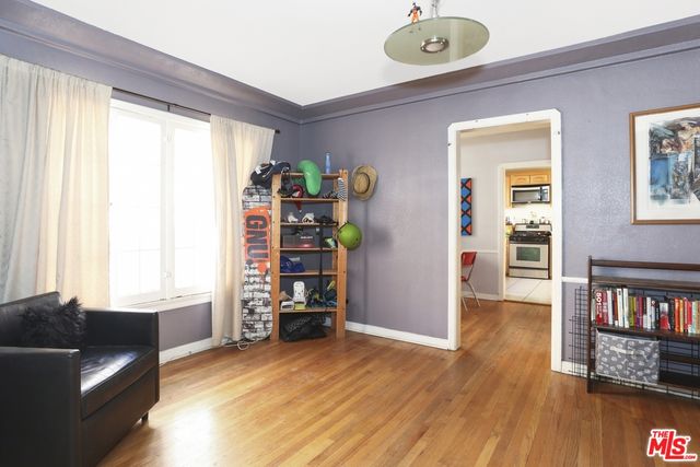 a living room with furniture and a book shelf