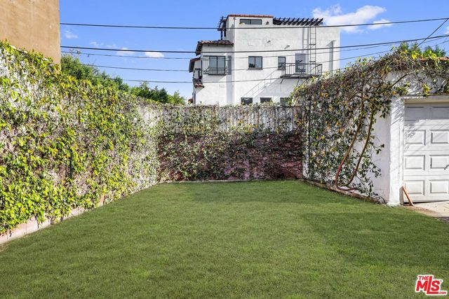 a view of a large building with a big yard and large trees