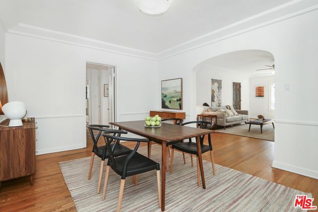 a view of a livingroom and dining room with wooden floor windows