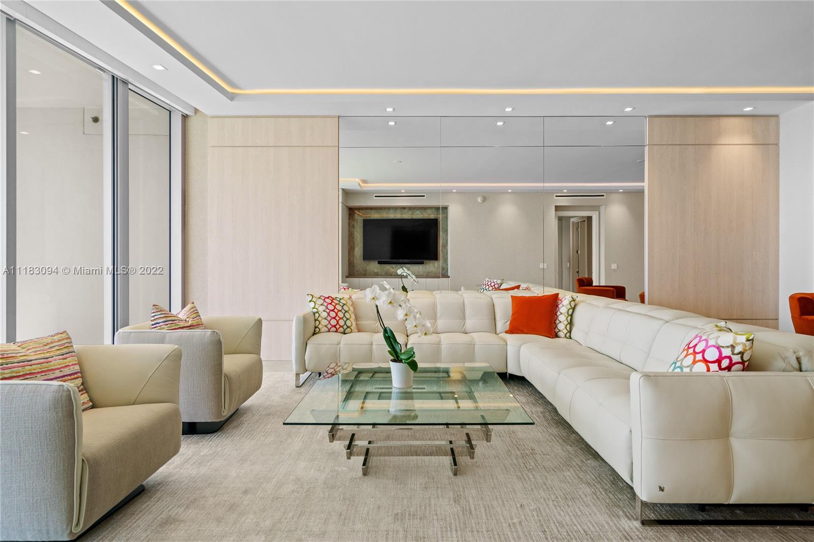 18501 Collins Avenue, Unit 3302 Sunny Isles Beach, FL 33160 - Photo 13 of 48 a living room with furniture and a flat screen tv