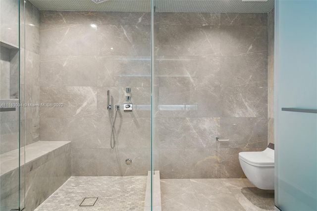 a bathroom with a shower and a toilet