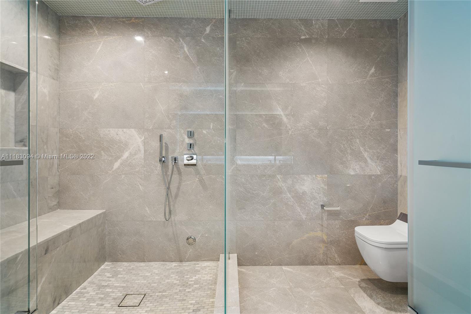 18501 Collins Avenue, Unit 3302 Sunny Isles Beach, FL 33160 - Photo 16 of 48 a bathroom with a shower and a toilet