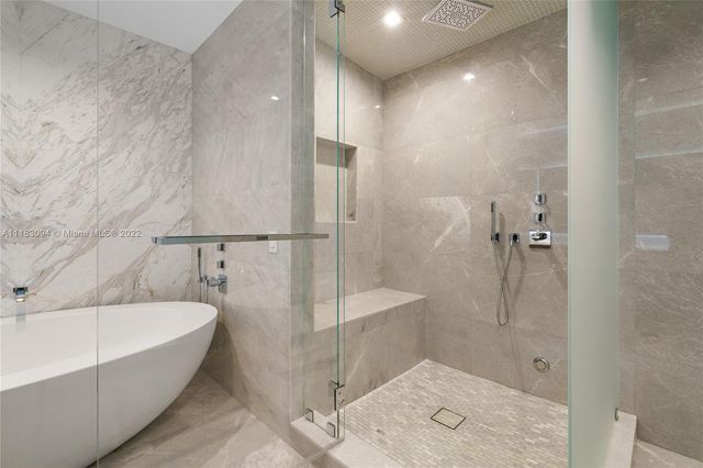 a bathroom with a bathtub and shower