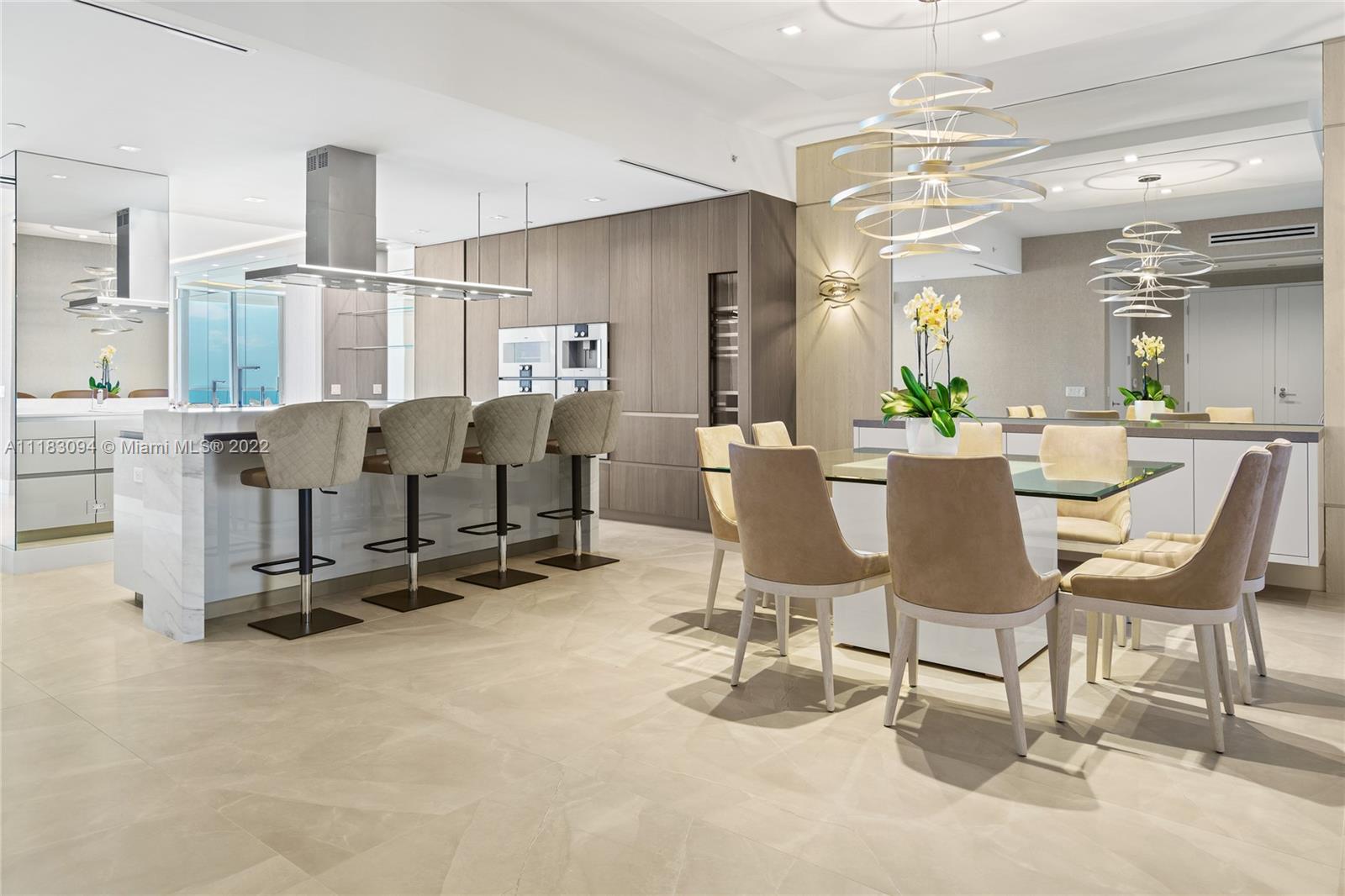 18501 Collins Avenue, Unit 3302 Sunny Isles Beach, FL 33160 - Photo 2 of 48 a view of a dining room with furniture