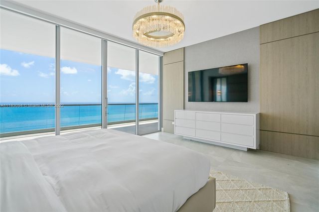 a view of an empty room with a fireplace and a fan