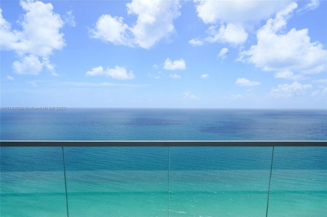 a view of a big yard of grass and hall with wooden floor