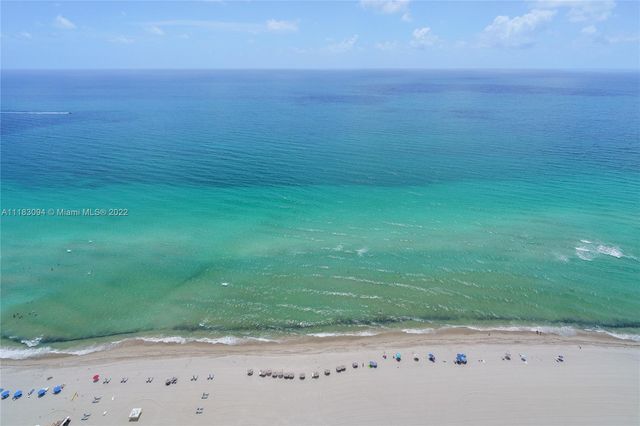 a view of a field with an ocean