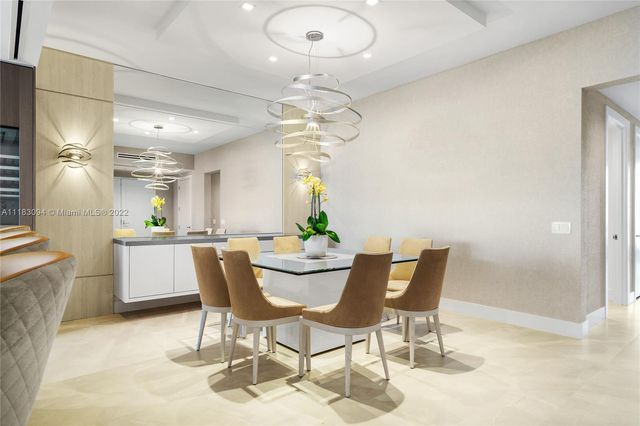 a view of a dining room with furniture and a chandelier fan
