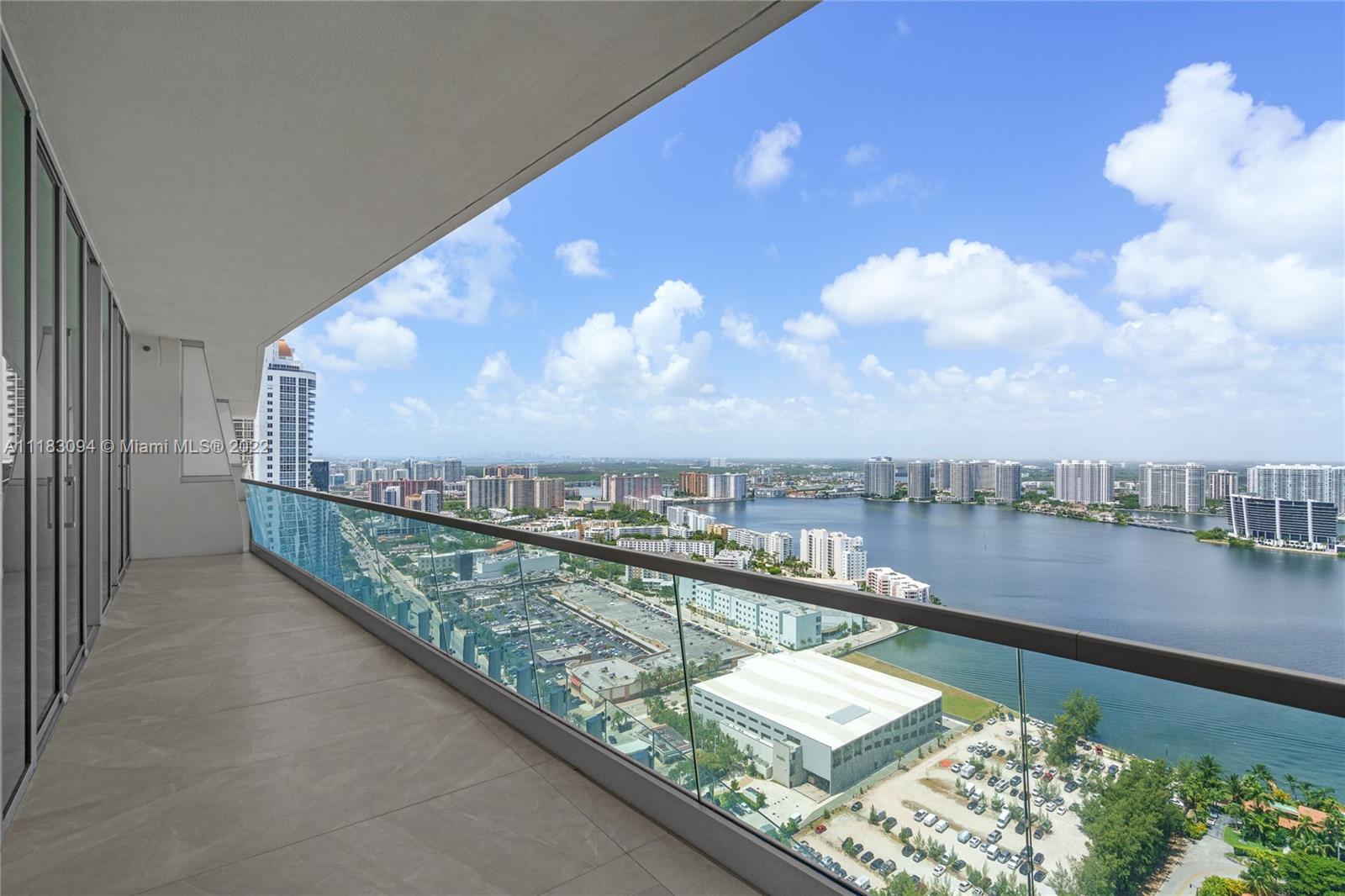 18501 Collins Avenue, Unit 3302 Sunny Isles Beach, FL 33160 - Photo 32 of 48 a view of a city from a balcony