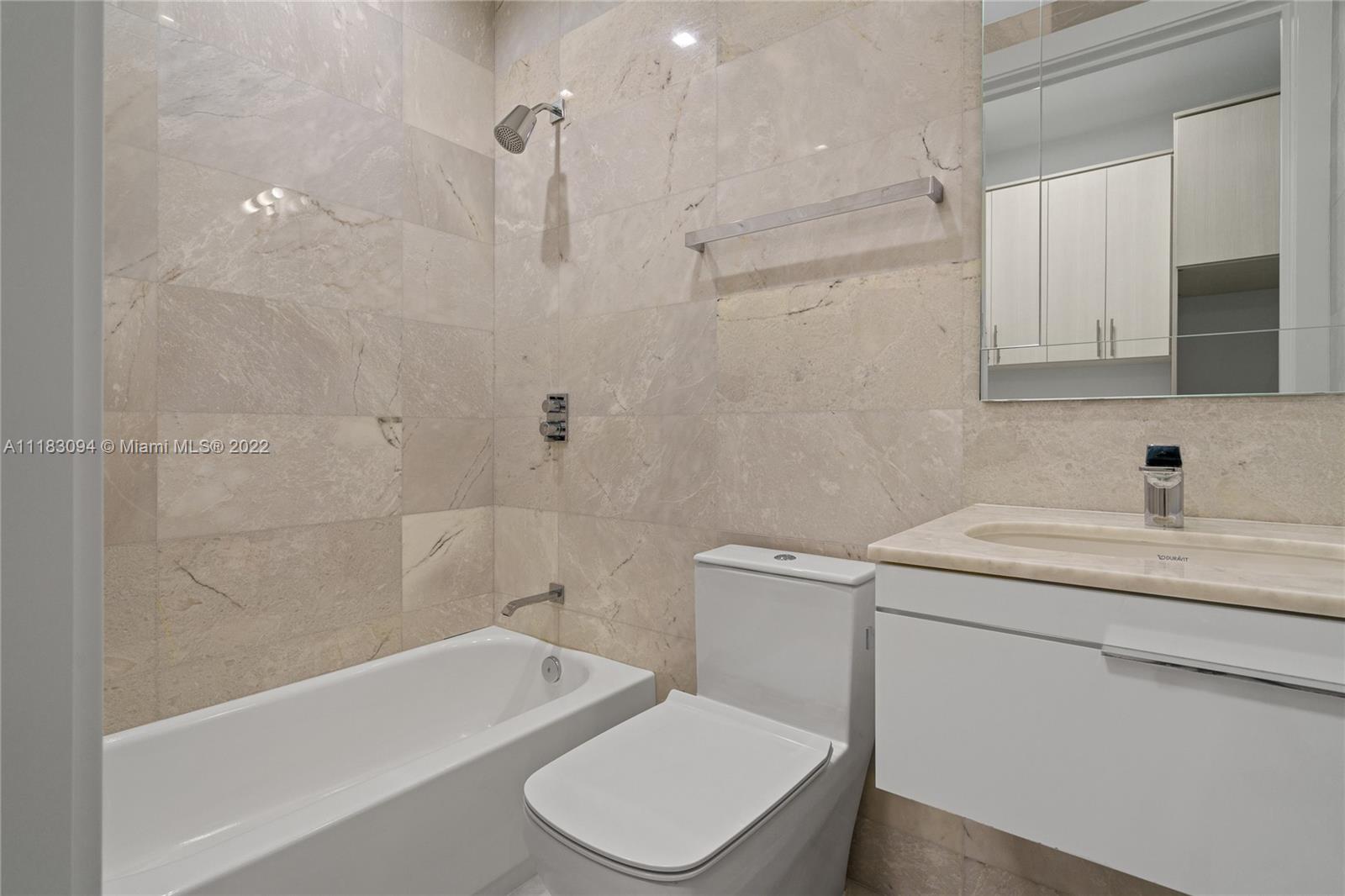 18501 Collins Avenue, Unit 3302 Sunny Isles Beach, FL 33160 - Photo 37 of 48 a bathroom with a sink toilet and shower