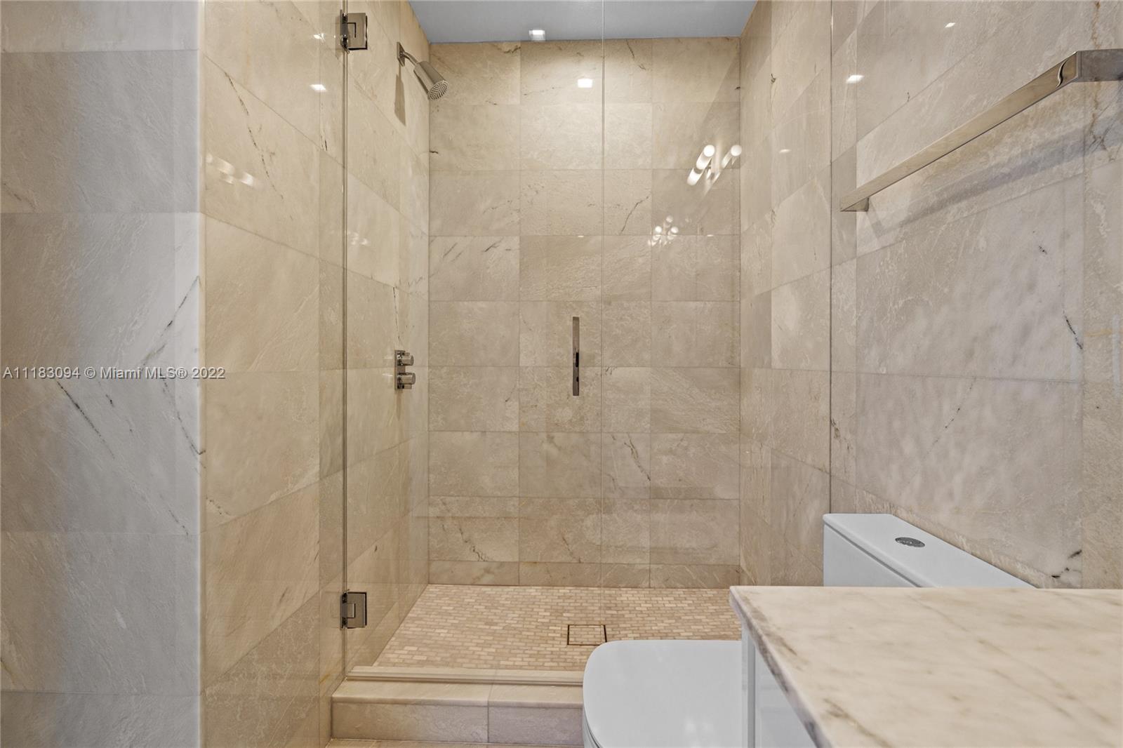 18501 Collins Avenue, Unit 3302 Sunny Isles Beach, FL 33160 - Photo 40 of 48 a bathroom with a sink toilet and shower