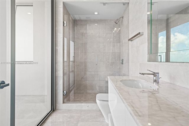 a bathroom with a bathtub shower sink and toilet