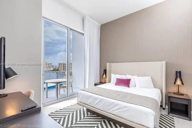 a bedroom with a bed and a flat screen tv