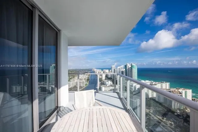 a view of a balcony with table and chairs