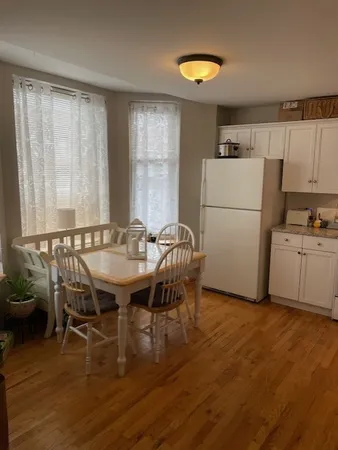 a dining room with furniture and wooden floor