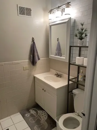 a bathroom with a sink toilet and mirror