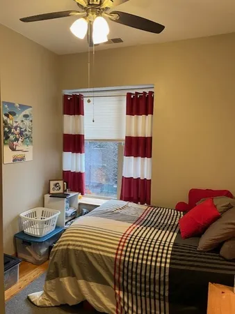 a bedroom with bed and a chandelier