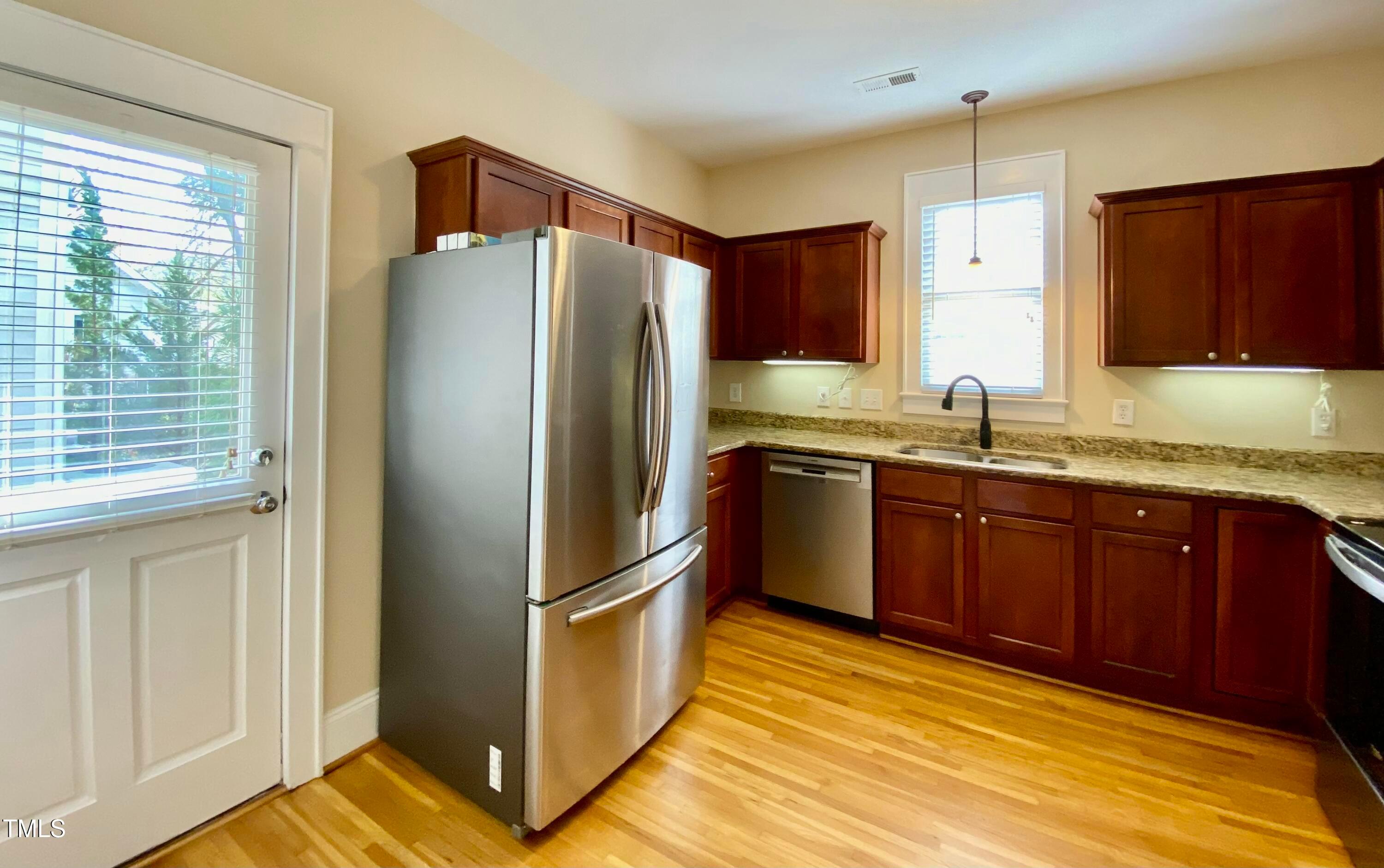 813 Clarendon Street Durham, NC 27705 - Photo 12 of 36 a kitchen with stainless steel appliances granite countertop a refrigerator and a sink