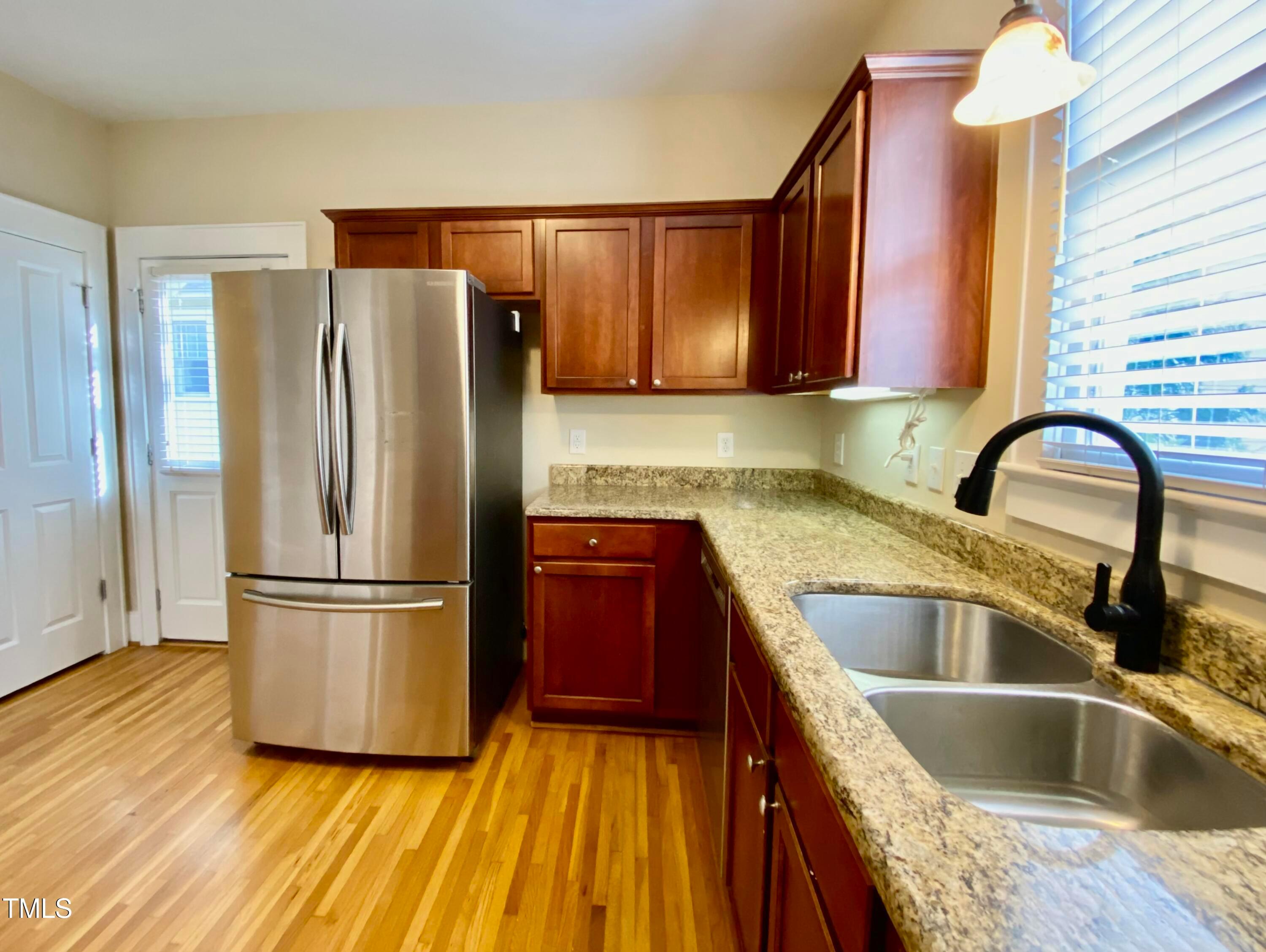 813 Clarendon Street Durham, NC 27705 - Photo 15 of 36 a kitchen with a refrigerator sink and cabinets