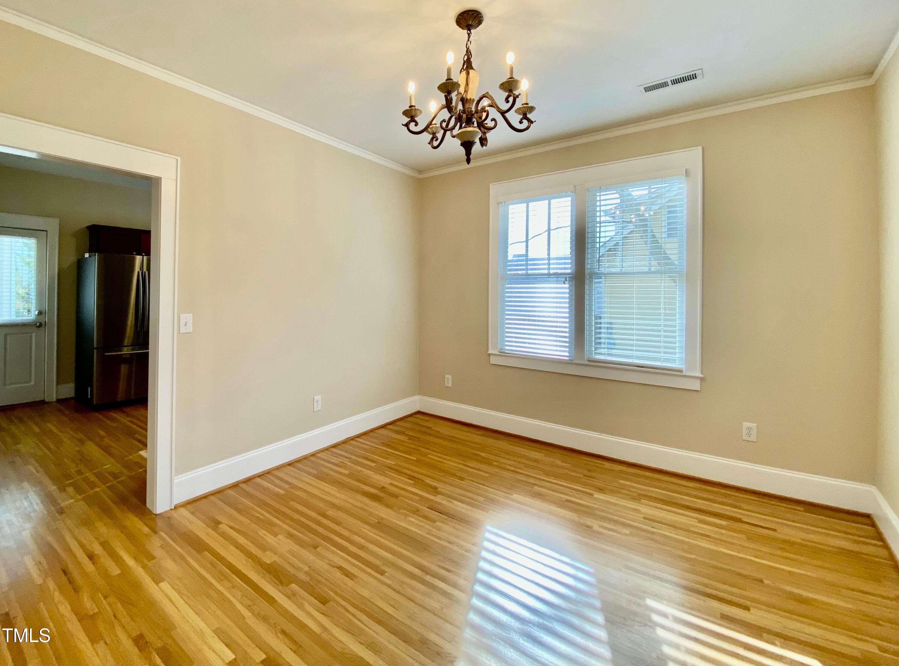 813 Clarendon Street Durham, NC 27705 - Photo 18 of 36 a view of empty room with wooden floor and fan