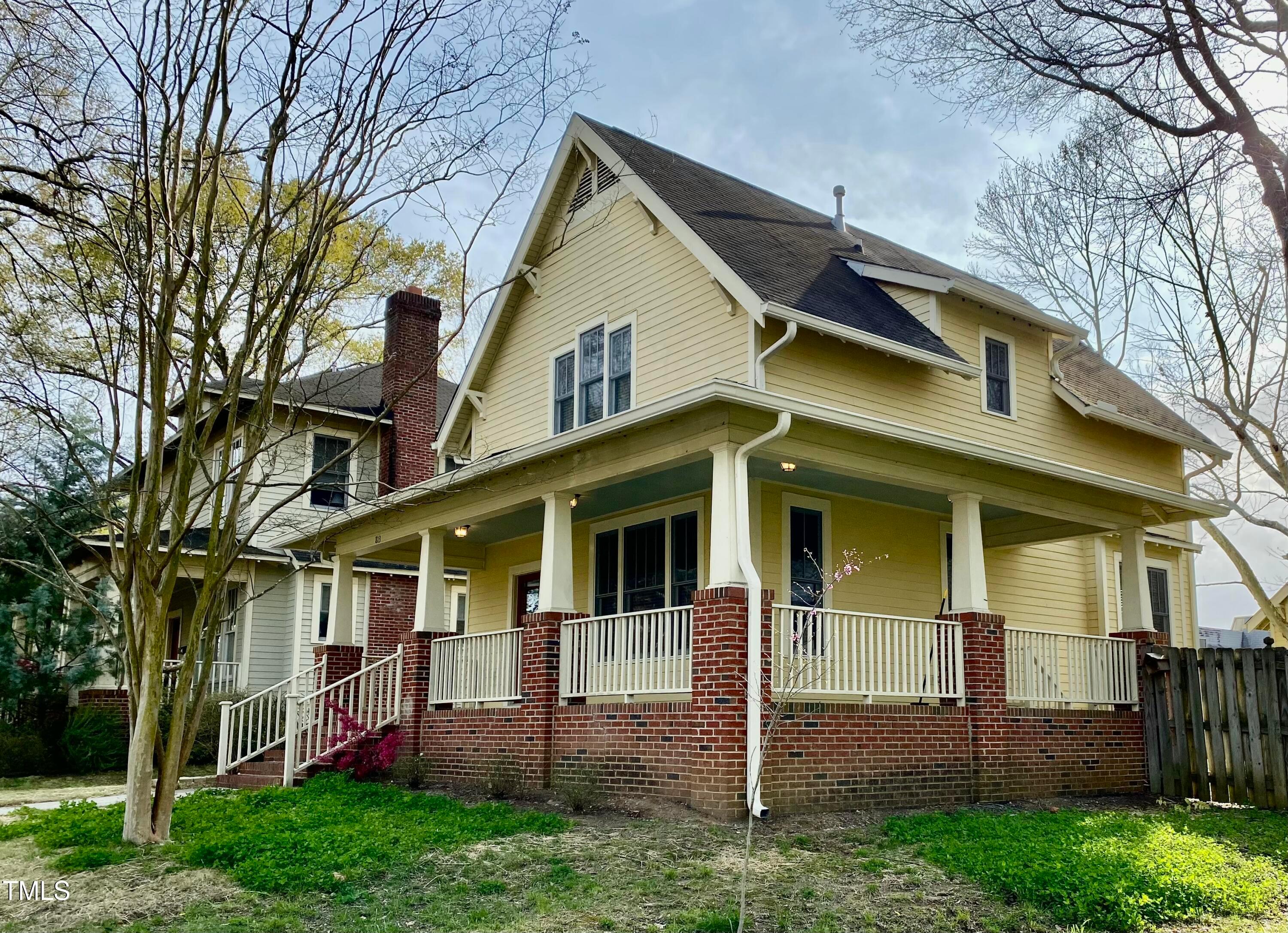 813 Clarendon Street Durham, NC 27705 - Photo 2 of 36 a view of a white house with a big yard and large tree