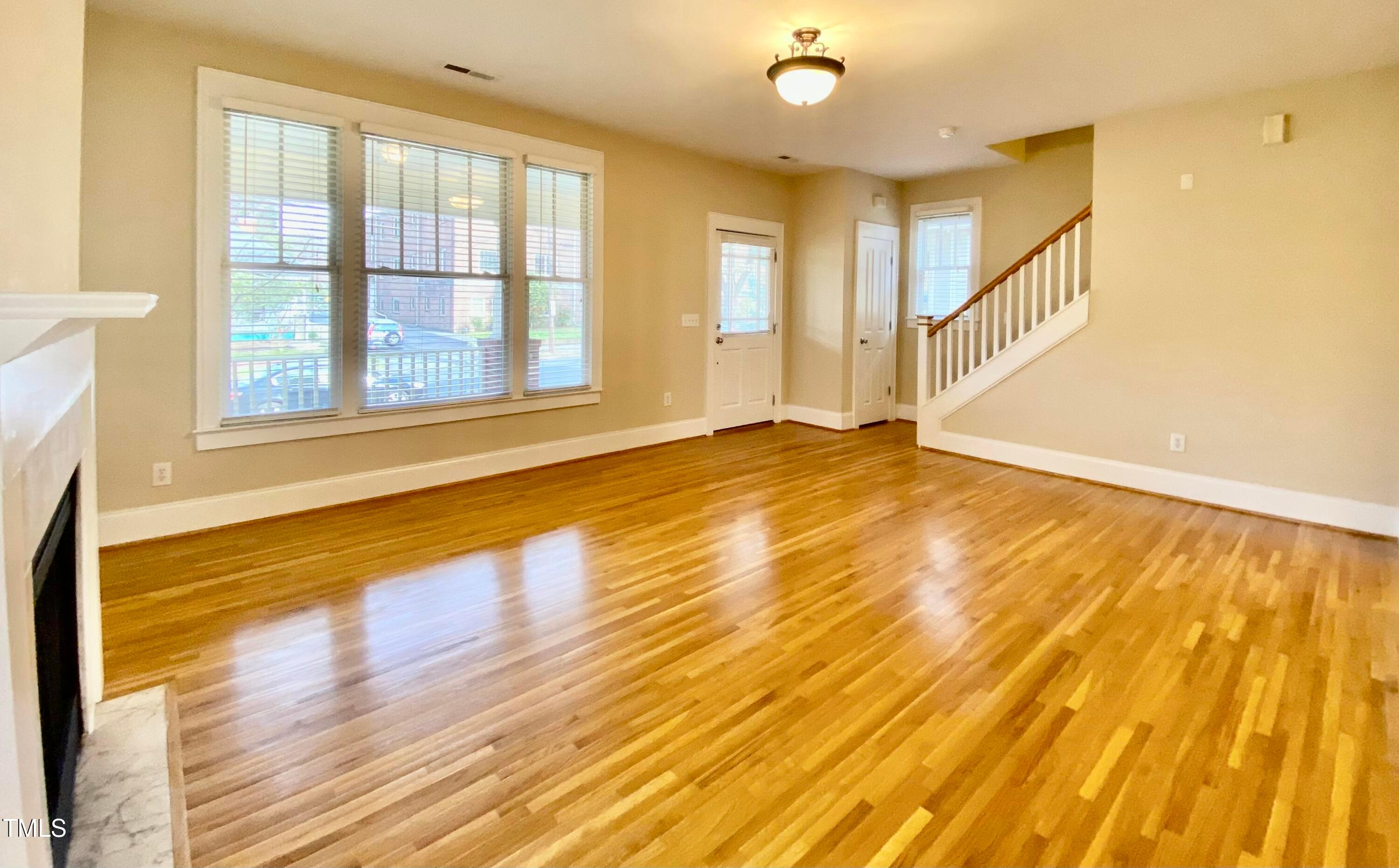 813 Clarendon Street Durham, NC 27705 - Photo 21 of 36 a view of an empty room with wooden floor and a window