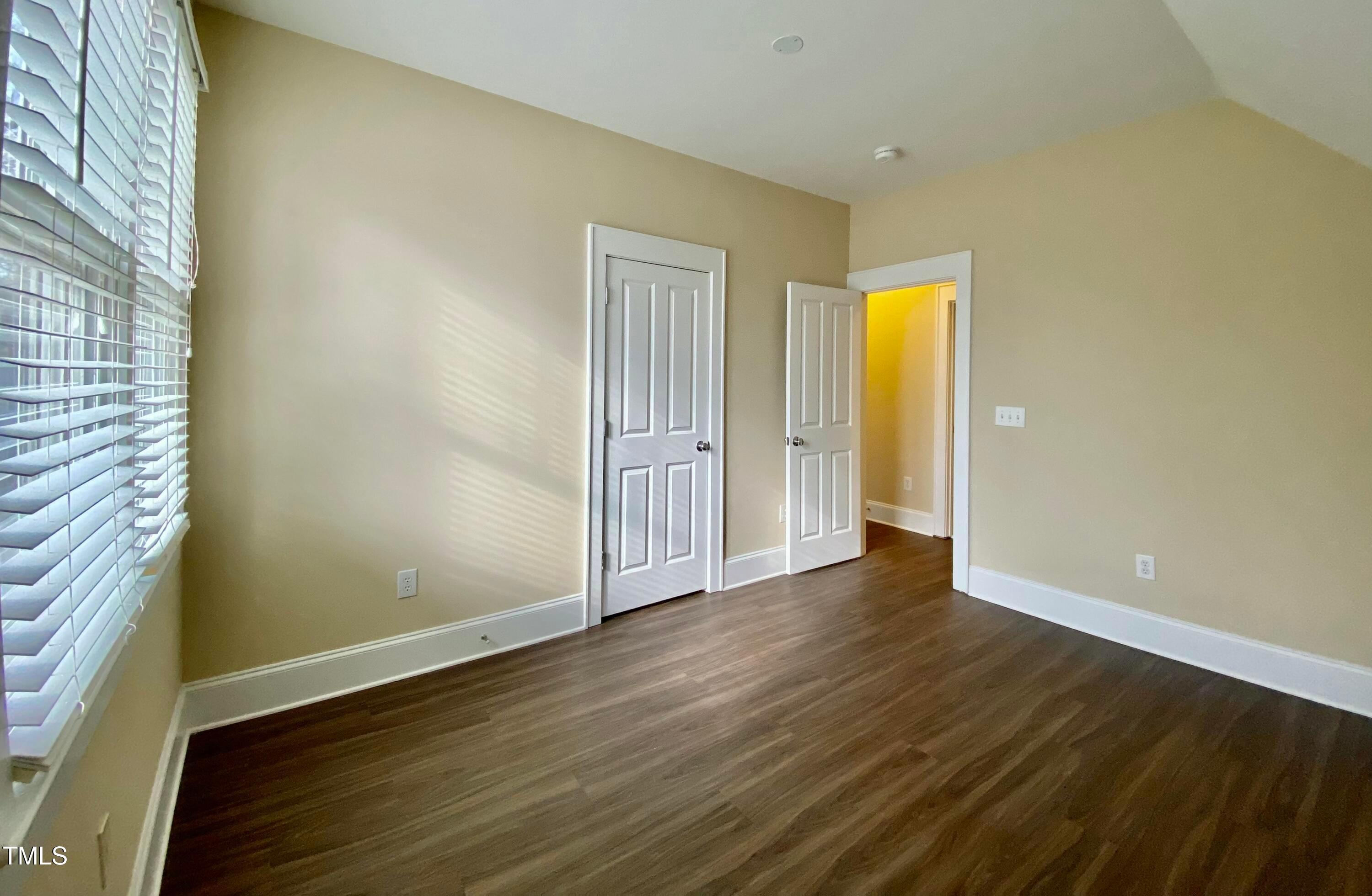 813 Clarendon Street Durham, NC 27705 - Photo 25 of 36 a view of an empty room with wooden floor and a window