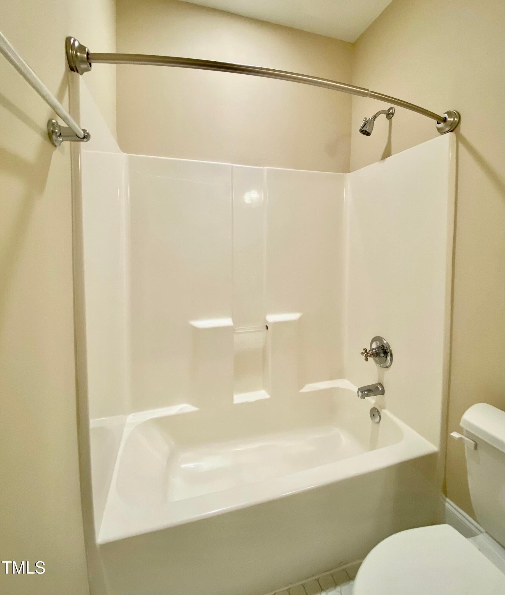813 Clarendon Street Durham, NC 27705 - Photo 27 of 36 a bathroom with a bathtub and a shower