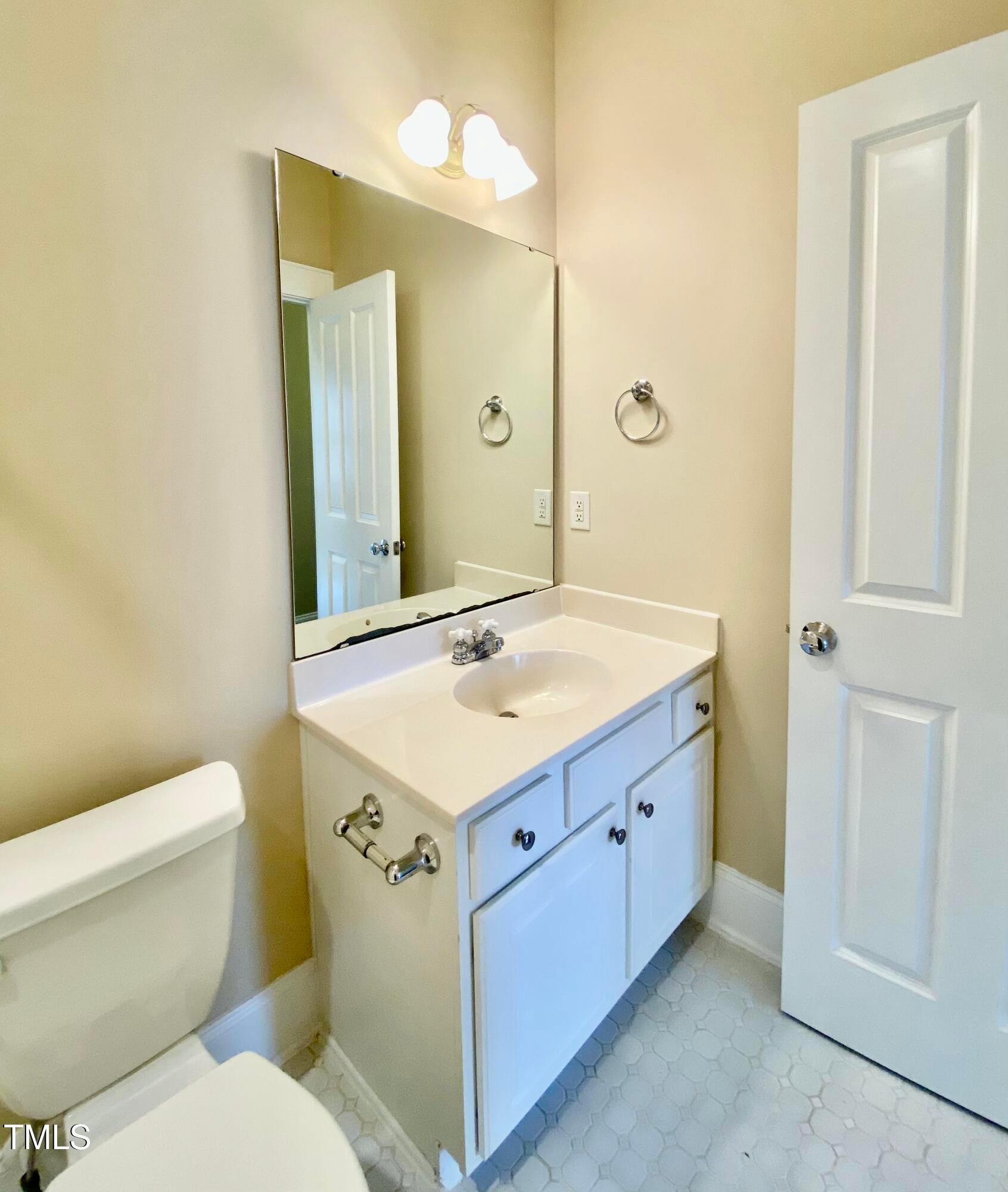 813 Clarendon Street Durham, NC 27705 - Photo 28 of 36 a bathroom with a sink a toilet and a mirror