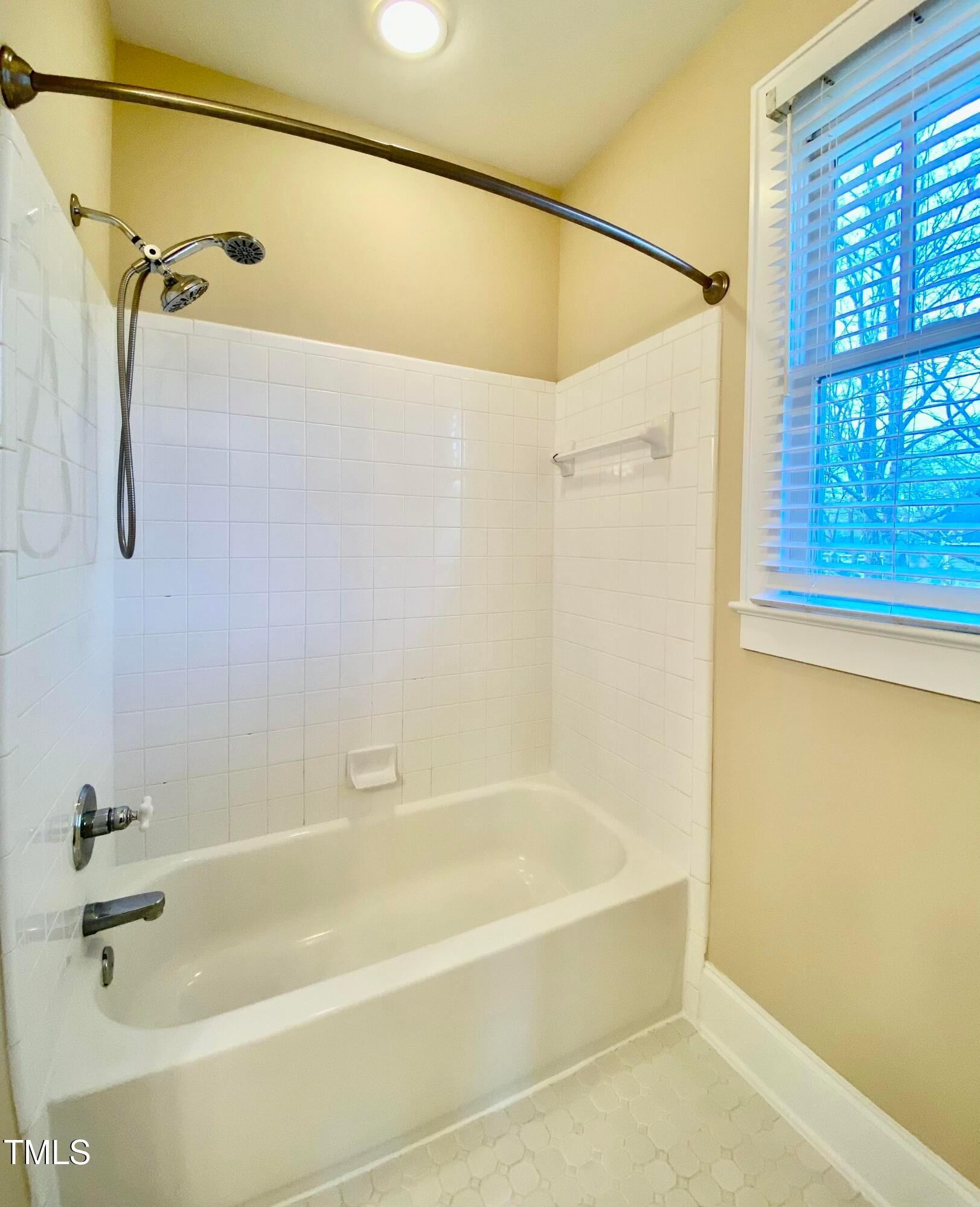 813 Clarendon Street Durham, NC 27705 - Photo 34 of 36 a bathroom with a shower and a bath tub
