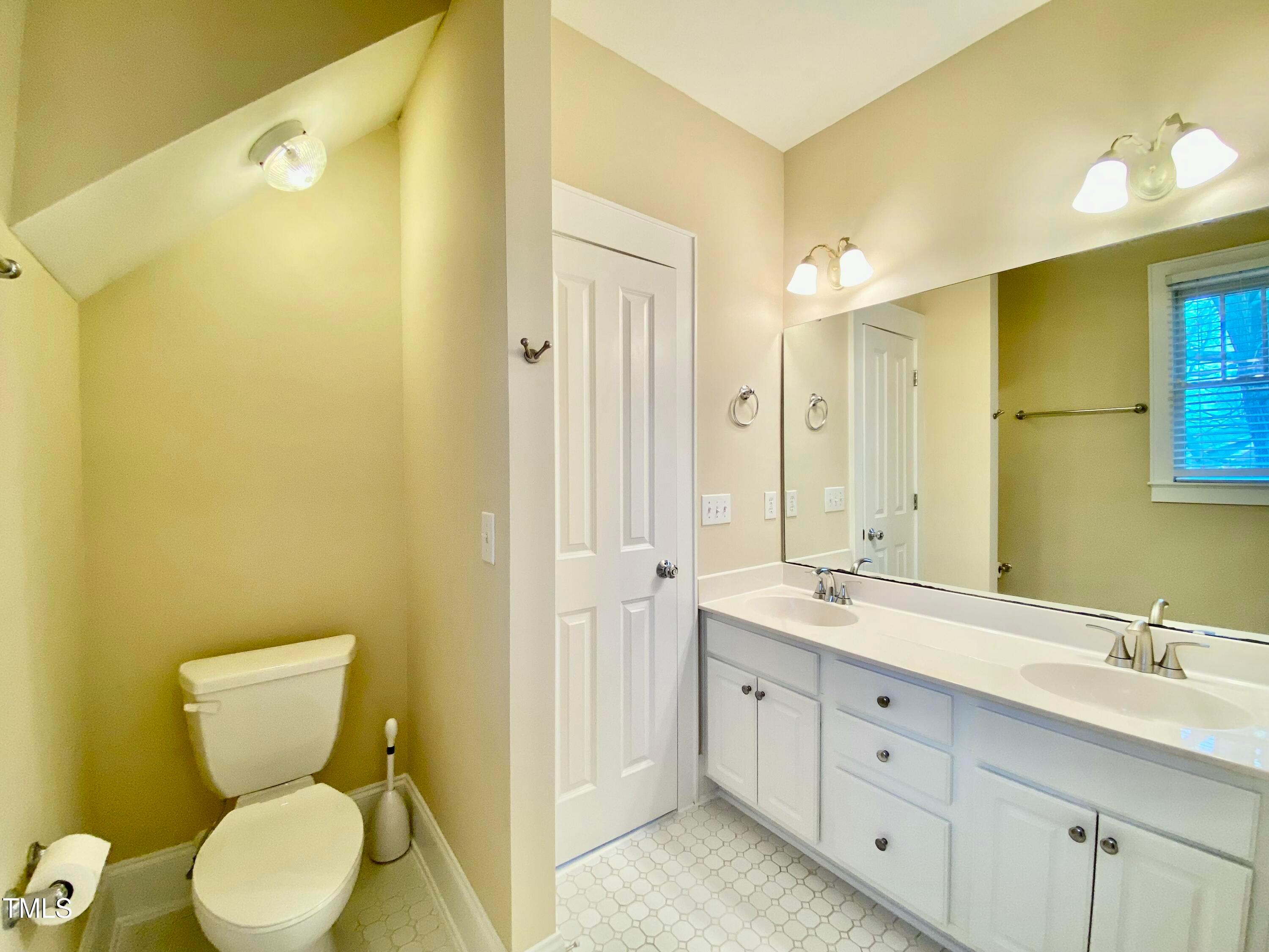 813 Clarendon Street Durham, NC 27705 - Photo 35 of 36 a bathroom with a double vanity sink mirror and toilet
