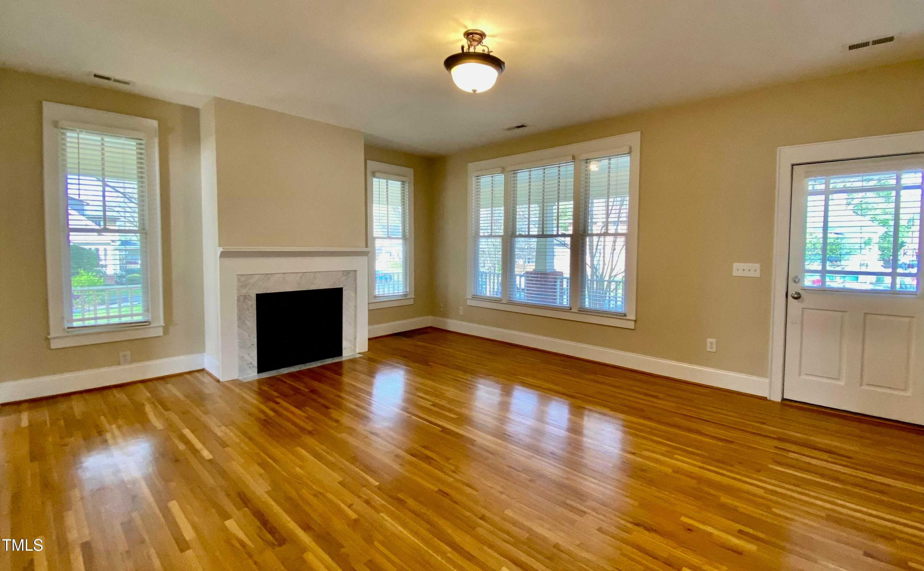 813 Clarendon Street Durham, NC 27705 - Photo 8 of 36 a view of an empty room with glass door and wooden floor