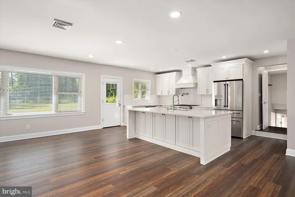 a kitchen with stainless steel appliances granite countertop a sink stove oven and refrigerator