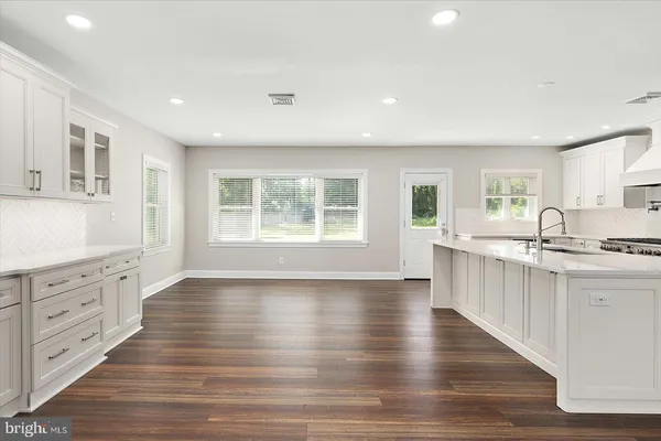 a kitchen with granite countertop a stove and a sink